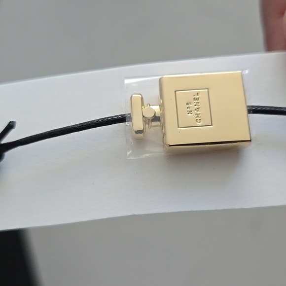Brand new never used CHANEL bracelet gold bottle charm N°5 adjustable black cord - Picture 3 of 6